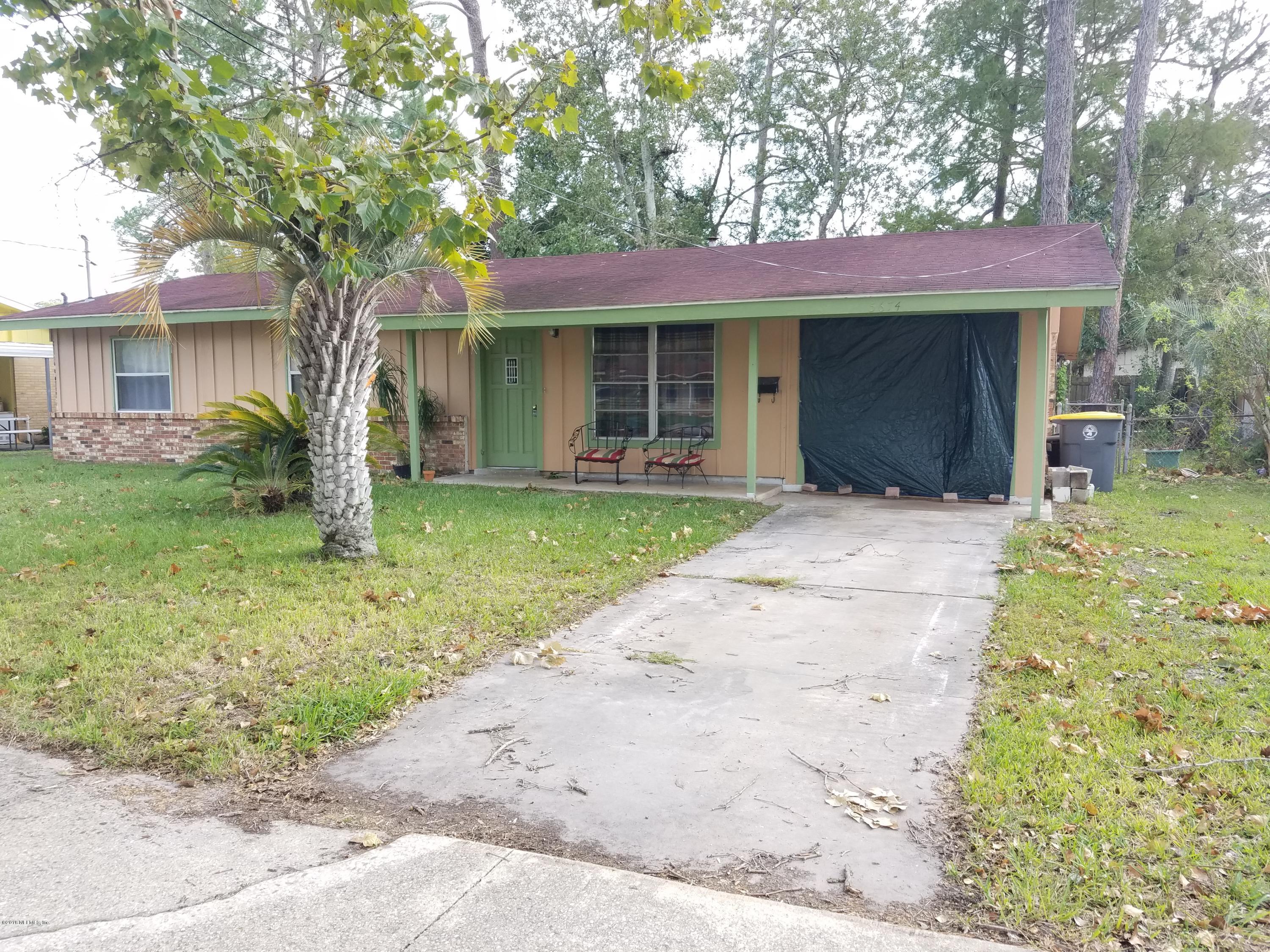 5674 Beney Road Jacksonville, FL 32207 - Photo 1 of 3 a front view of a house with garden