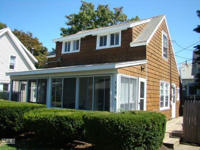 779 Fairfield Beach Road Fairfield, CT 06824 - Photo 1 of 1 a view of a white house with large windows and a small yard