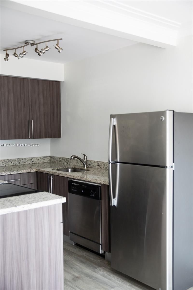 345 85th Street, Unit 2 Miami Beach, FL 33141 - Photo 6 of 13 a kitchen with a refrigerator sink and cabinets