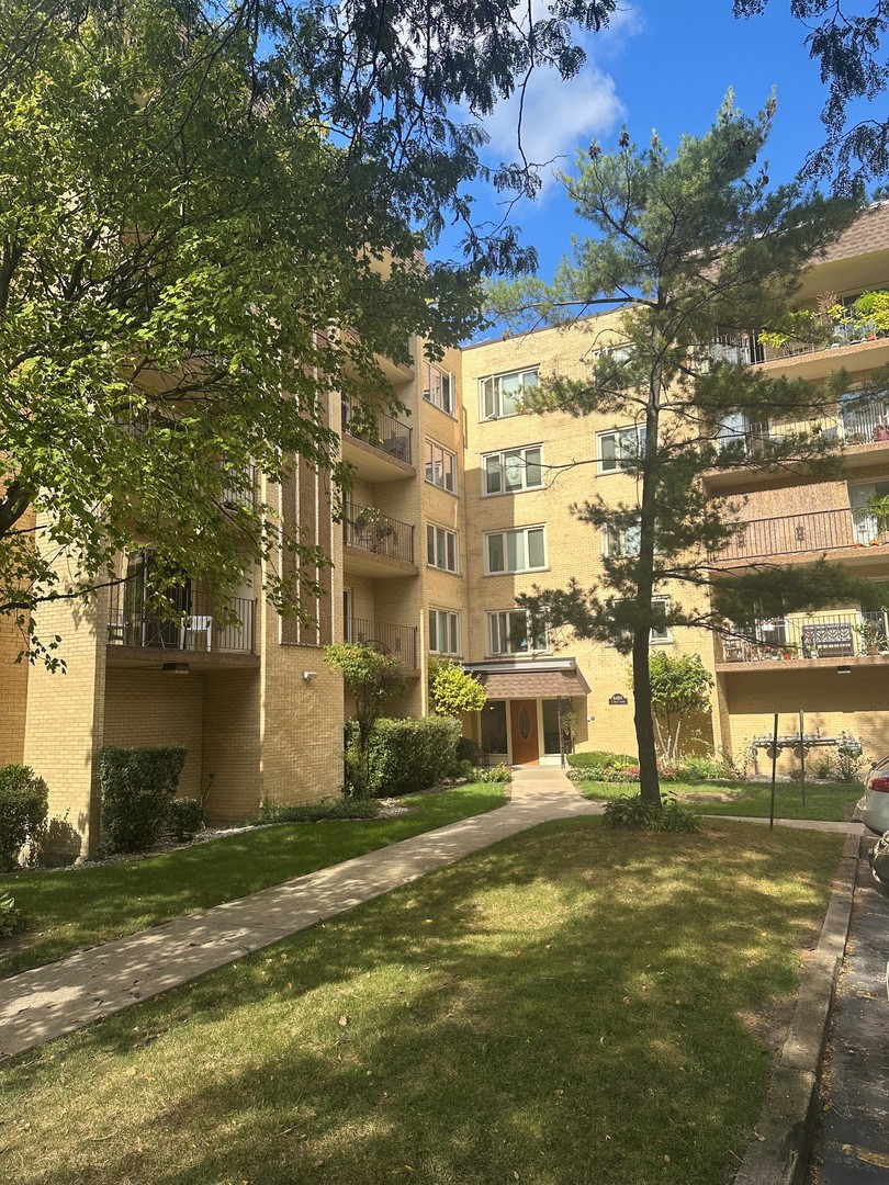 6460 West Belle Plaine Avenue, Unit 407 Chicago, IL 60634 - Photo 1 of 15 a front view of a building with street view