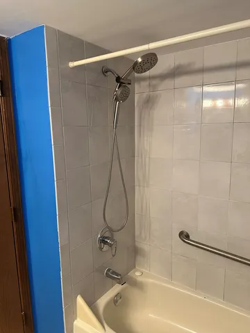 a bathroom with a shower and a sink