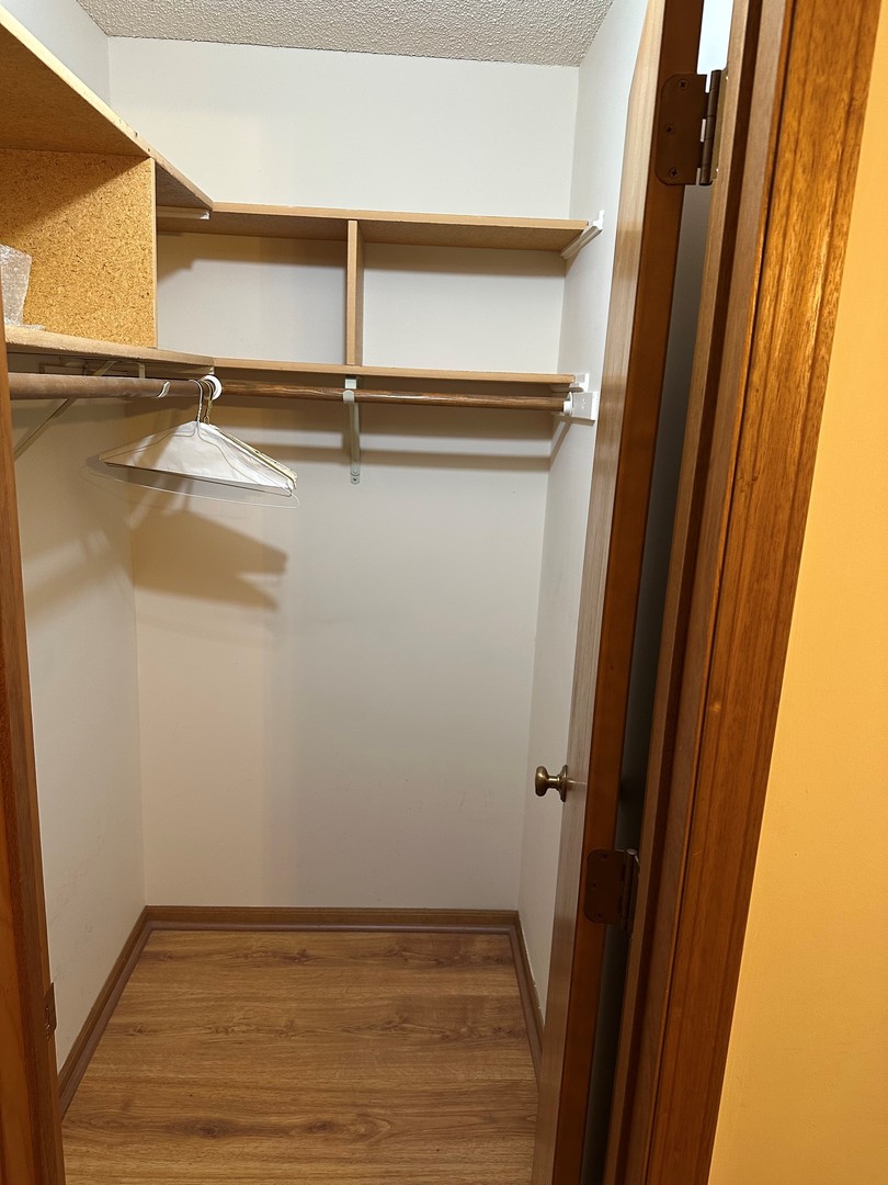 6460 West Belle Plaine Avenue, Unit 407 Chicago, IL 60634 - Photo 12 of 15 a view of a room with wooden floor and white wall