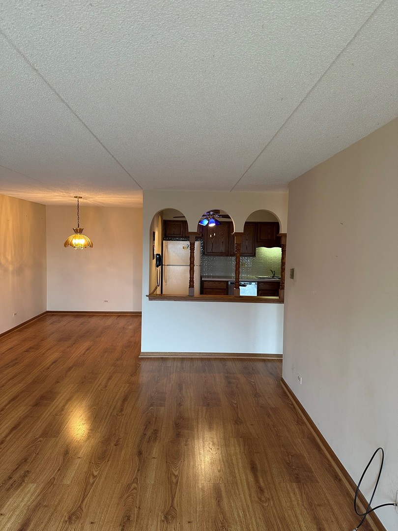 6460 West Belle Plaine Avenue, Unit 407 Chicago, IL 60634 - Photo 3 of 15 a view of a room with wooden floor