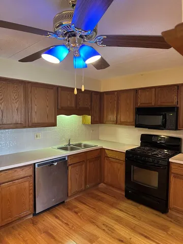a kitchen with stainless steel appliances a stove a sink and a counter space