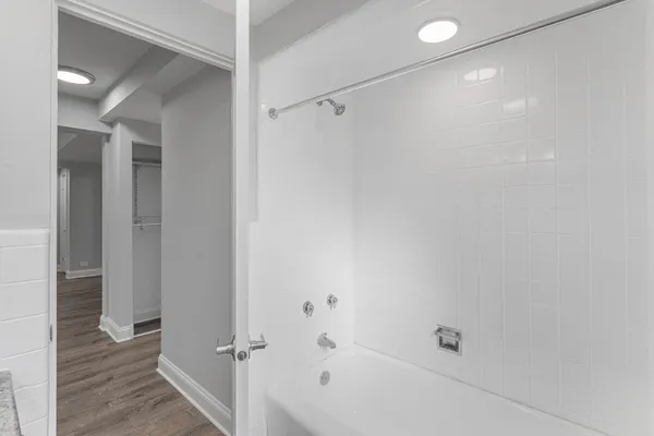 a bathroom with a bathtub and a shower