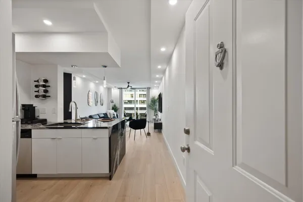 a kitchen with stainless steel appliances a sink stove and cabinets