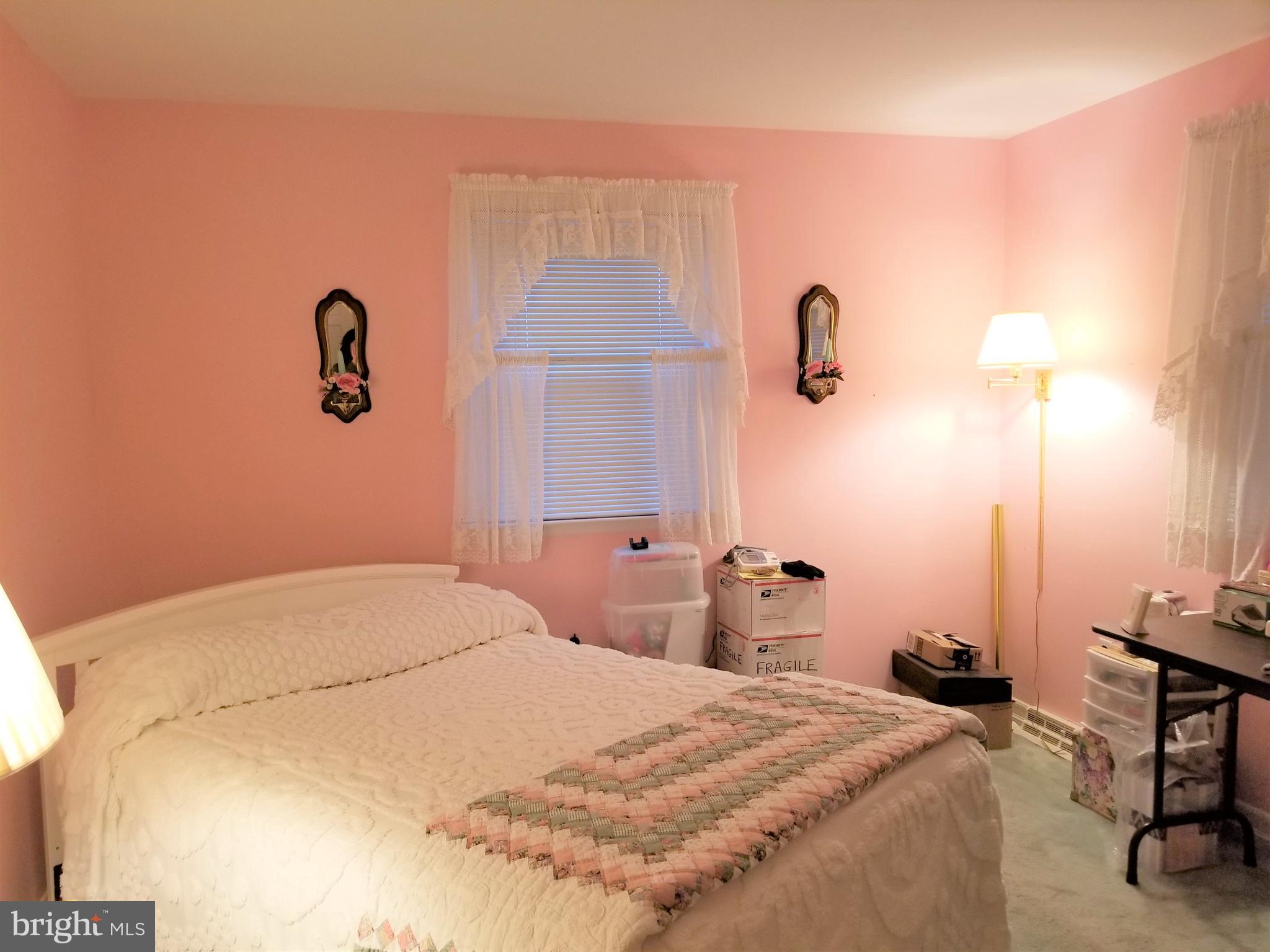 150 Kansas Road Pennsville, NJ 08070 - Photo 11 of 20 a bedroom with a bed and a table with potted plants