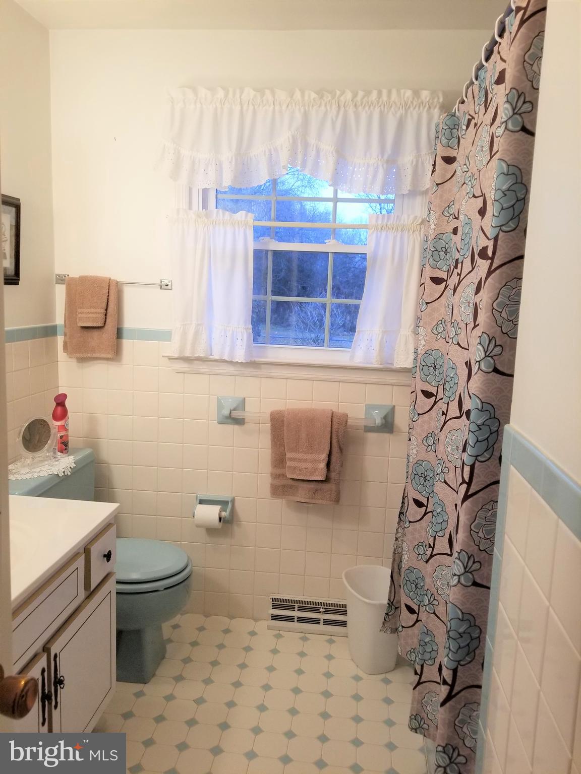 150 Kansas Road Pennsville, NJ 08070 - Photo 13 of 20 a bathroom with a sink a toilet and shower curtain