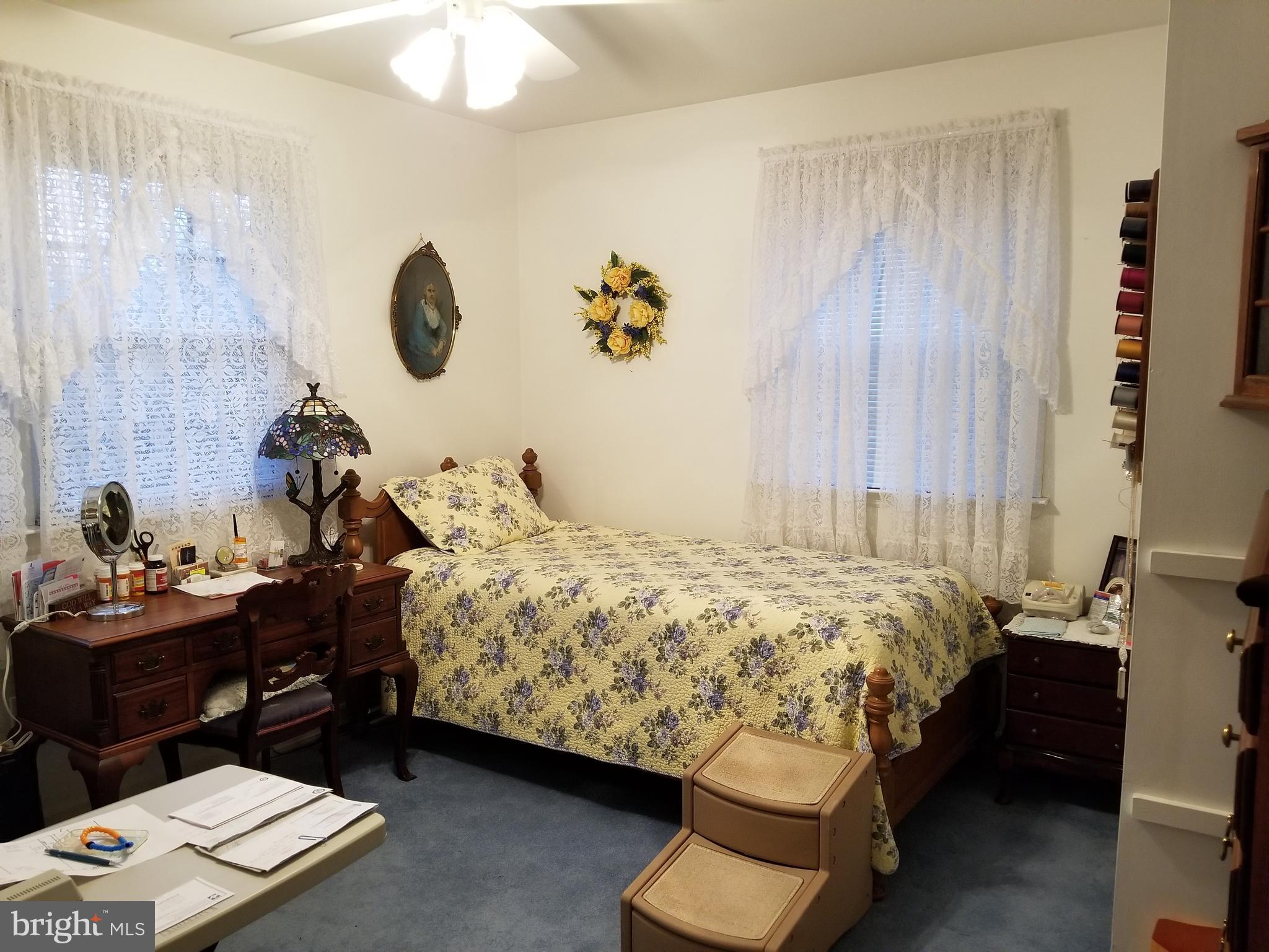 150 Kansas Road Pennsville, NJ 08070 - Photo 14 of 20 a bedroom with a bed and a chandelier