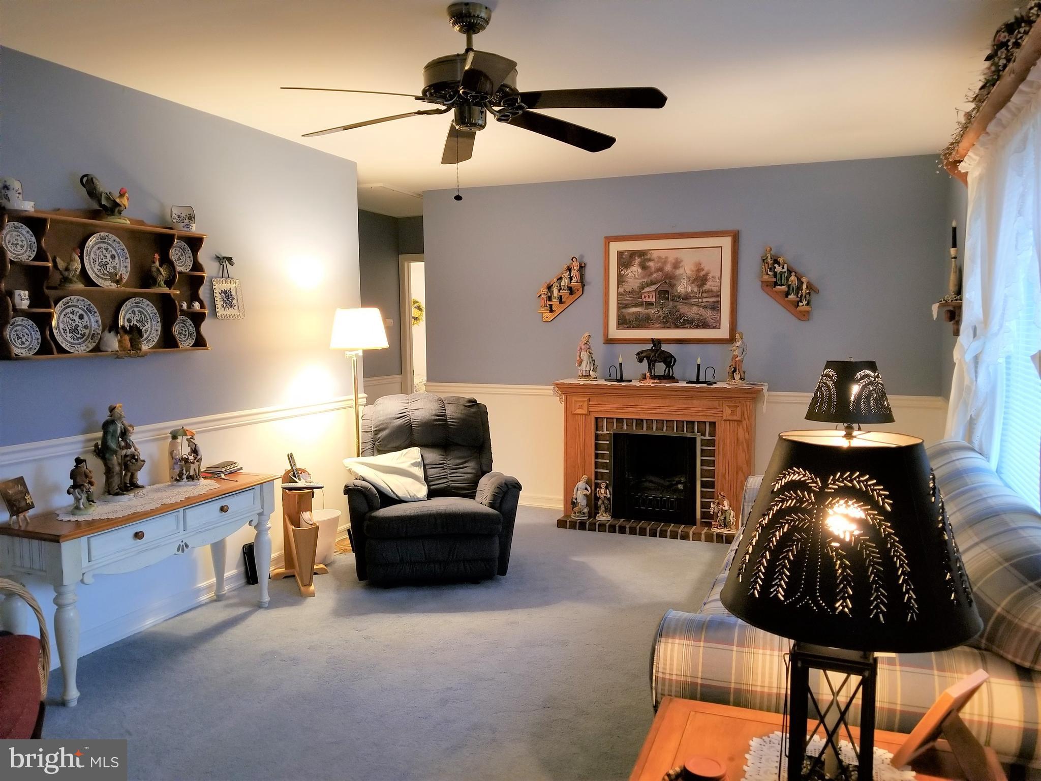 150 Kansas Road Pennsville, NJ 08070 - Photo 7 of 20 a living room with furniture and a fireplace
