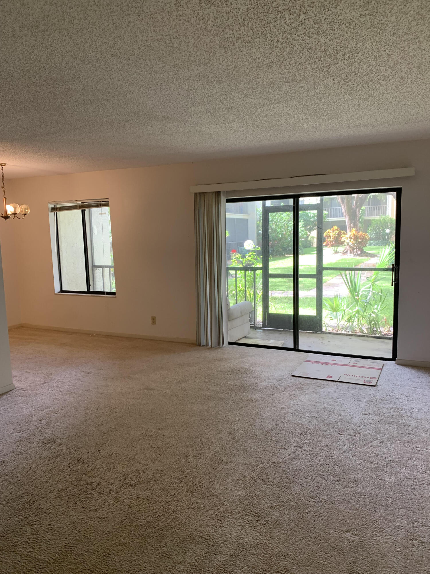 150 Pineview Road, Unit I4 Jupiter, FL 33469 - Photo 17 of 35 a view of a big room with windows and chandelier fan