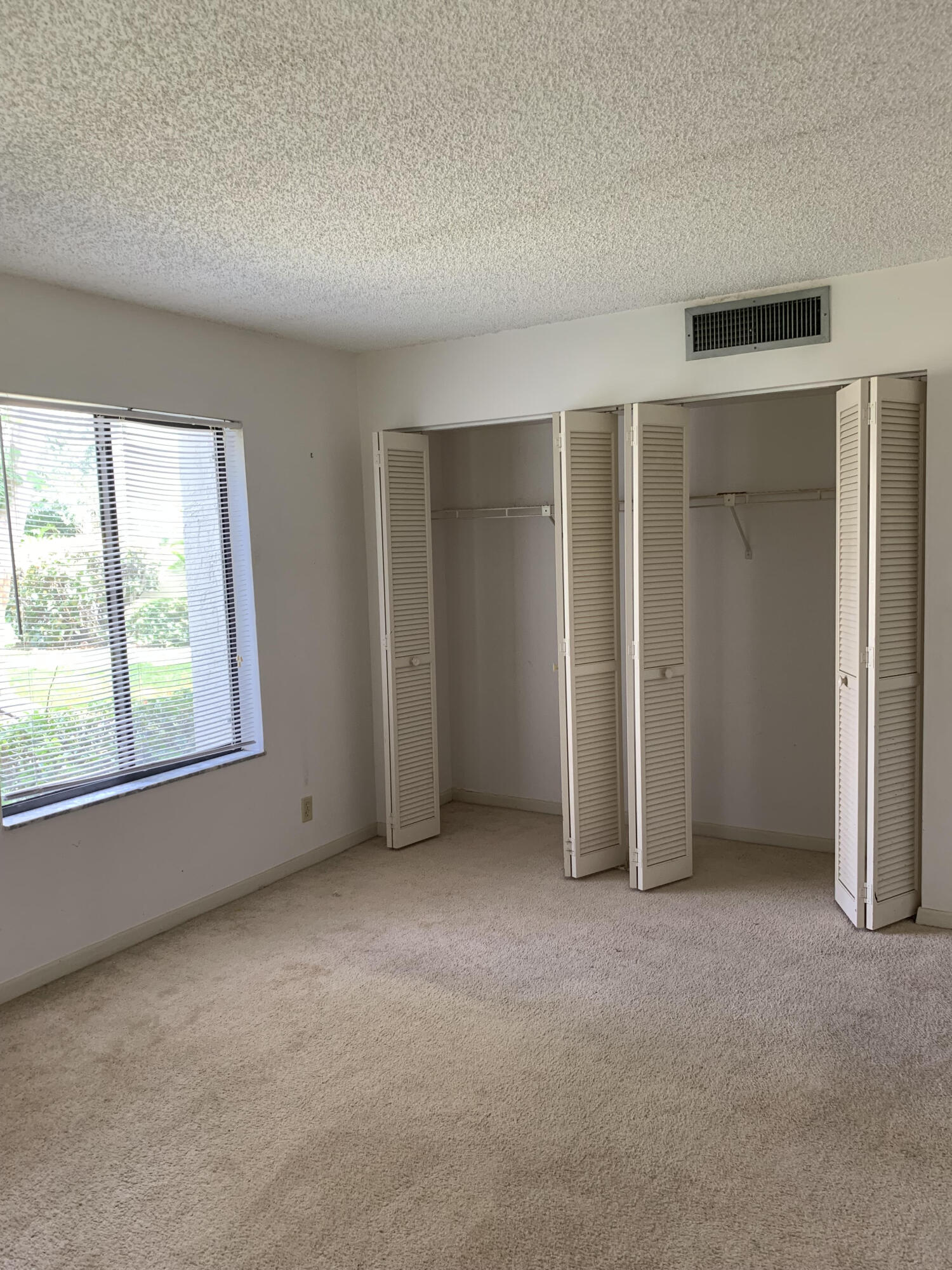 150 Pineview Road, Unit I4 Jupiter, FL 33469 - Photo 19 of 35 an empty room with windows and closet