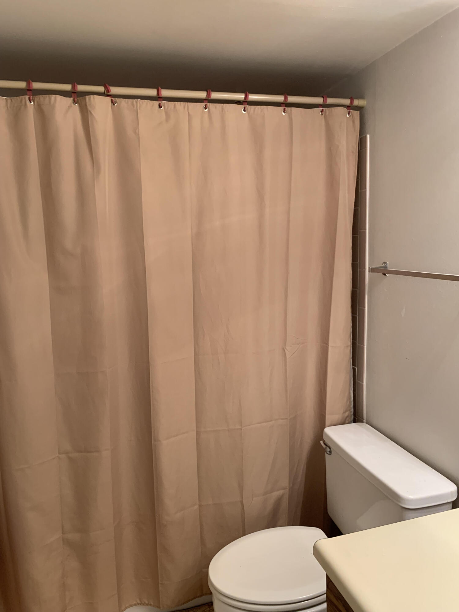 150 Pineview Road, Unit I4 Jupiter, FL 33469 - Photo 25 of 35 a white toilet sitting next to a shower curtain
