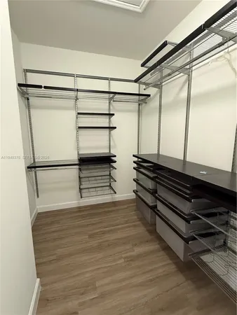 a spacious bathroom with a tub sink and mirror