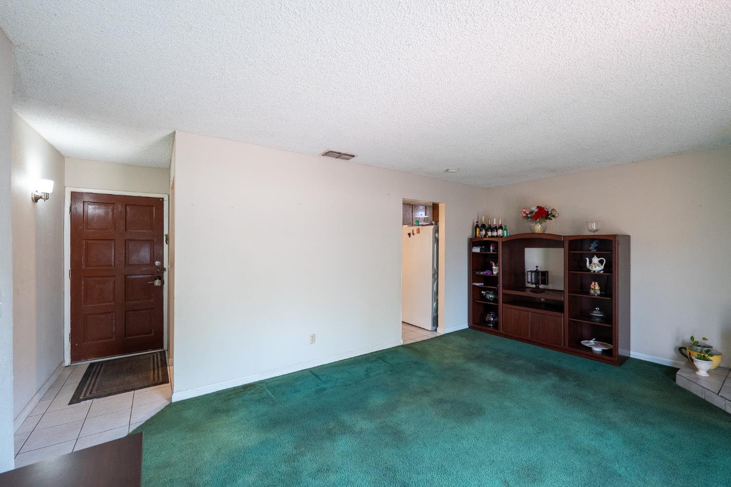859 11th Street Sanger, CA 93657 - Photo 1 of 28 a view of a livingroom with furniture and cabinet