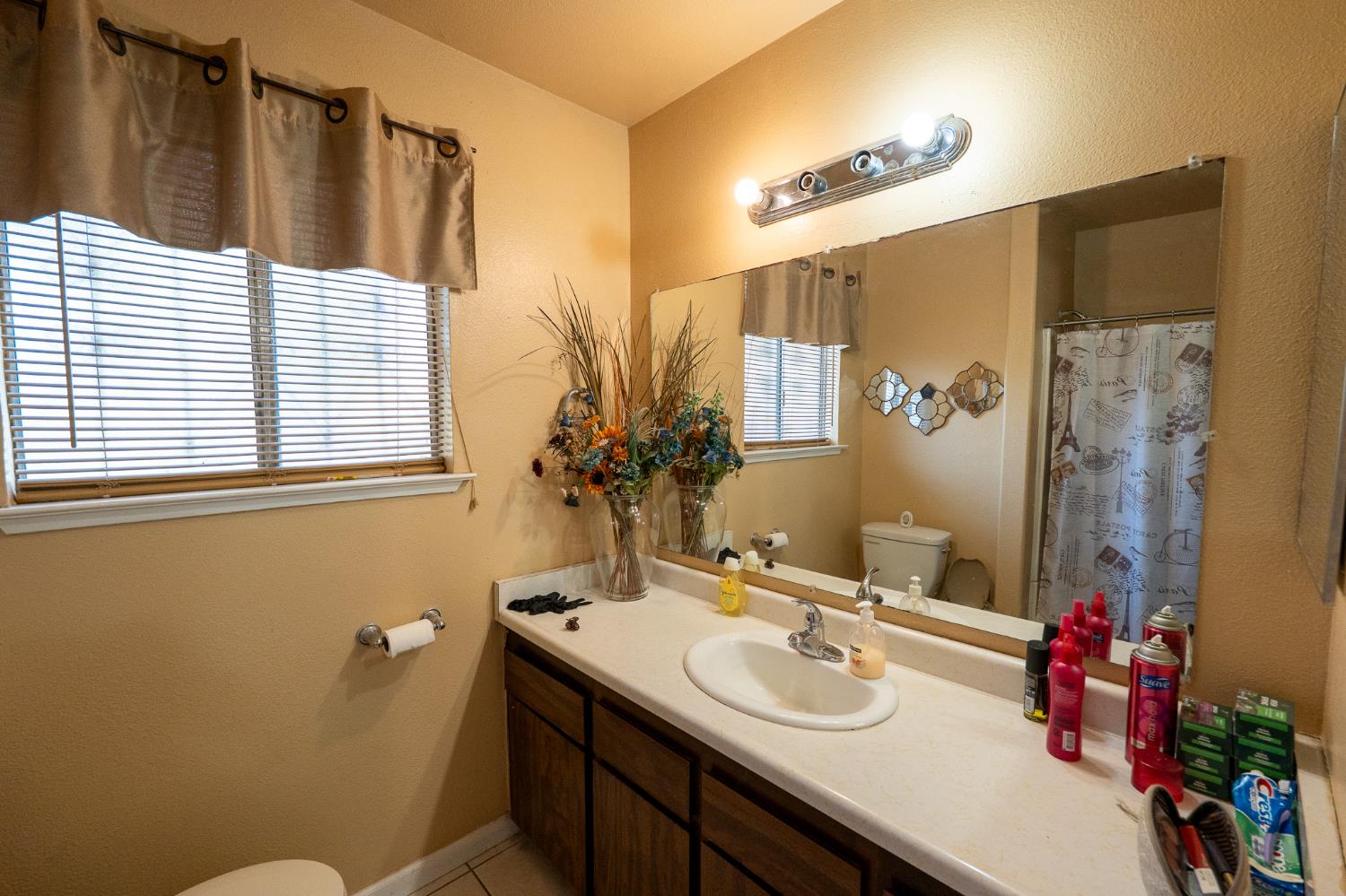 859 11th Street Sanger, CA 93657 - Photo 14 of 28 a bathroom with a sink toilet and shower