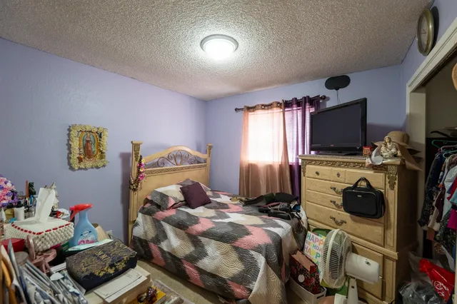 a bedroom with a bed and a tv