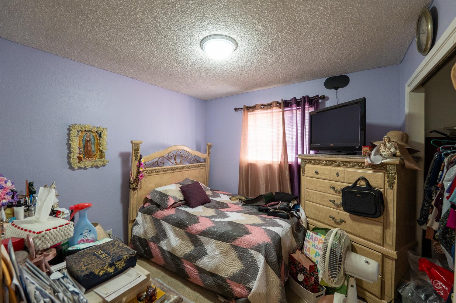 859 11th Street Sanger, CA 93657 - Photo 16 of 28 a bedroom with a bed and a tv