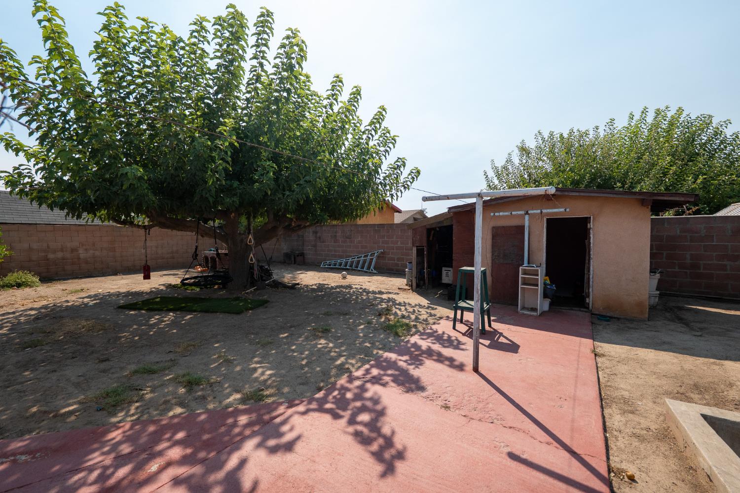 859 11th Street Sanger, CA 93657 - Photo 18 of 28 a view of a house with backyard and sitting area