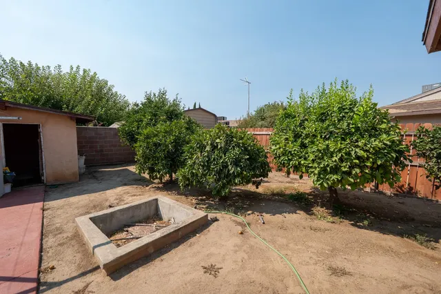a backyard of a house with a yard and outdoor seating