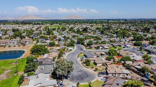 an aerial view of a residential houses with outdoor space