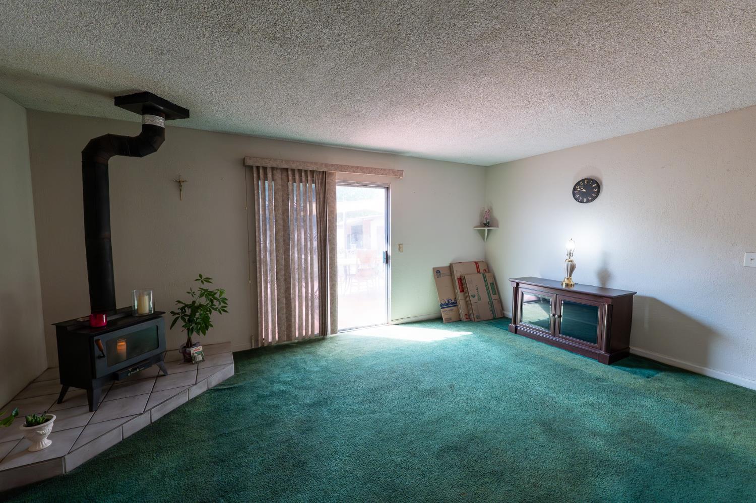 859 11th Street Sanger, CA 93657 - Photo 4 of 28 a living room with furniture and a flat screen tv