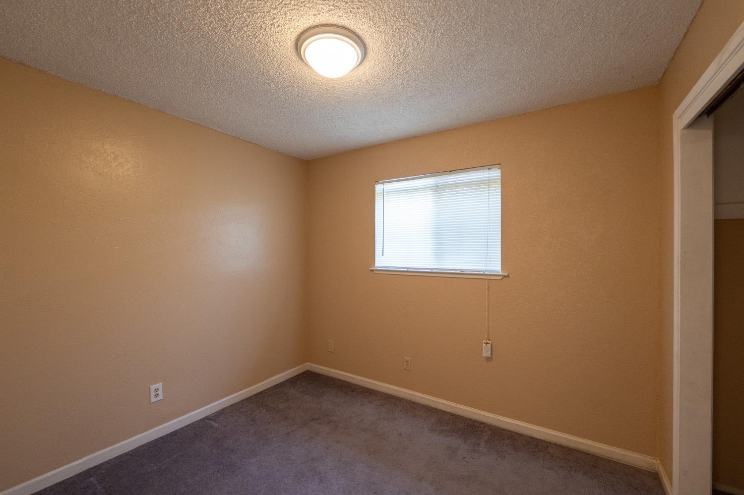 859 11th Street Sanger, CA 93657 - Photo 8 of 28 an empty room with a window
