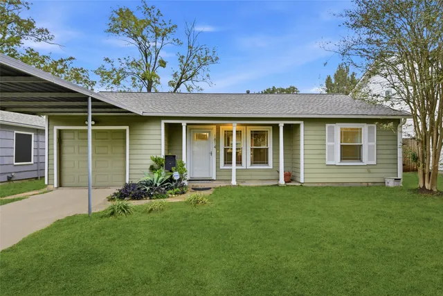 a front view of a house with a garden