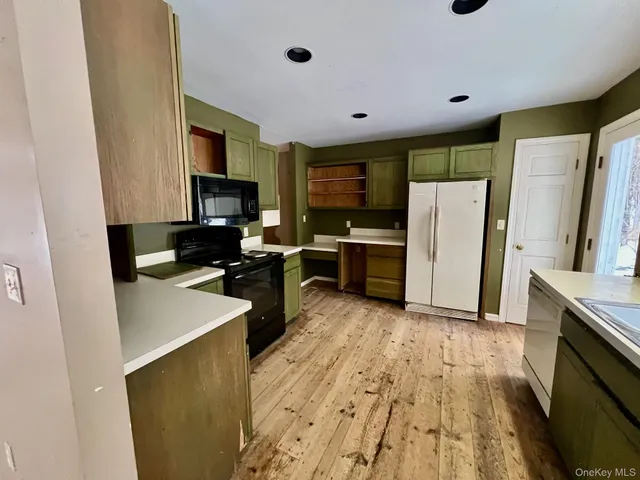 a kitchen with a refrigerator a sink and a stove