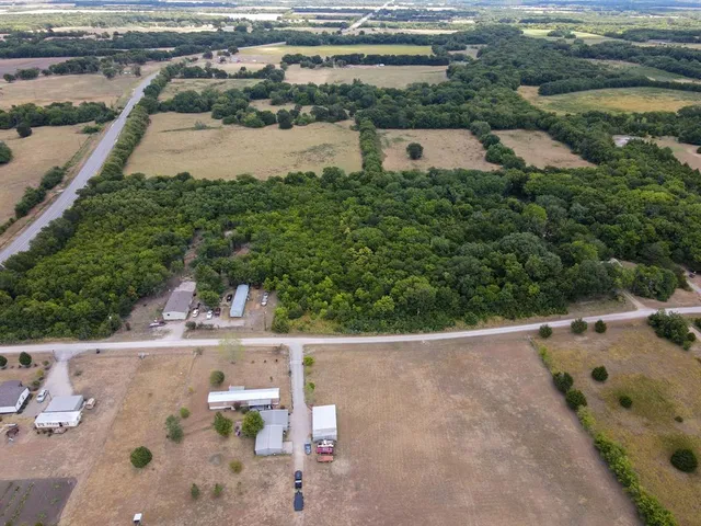 an aerial view of a house with a yard and lake view