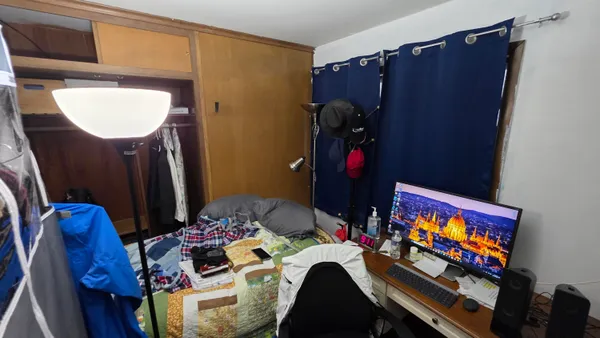 a bedroom with furniture and a flat screen tv