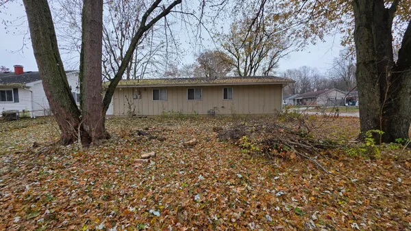 a tree in front of a white house