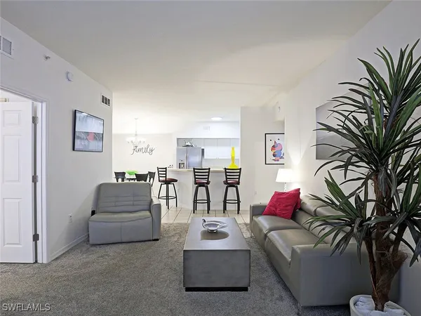 a living room with furniture and flowers