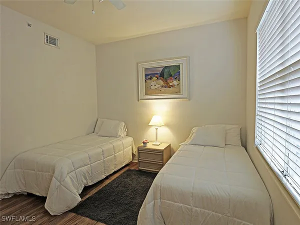 a bedroom with double bed and a window