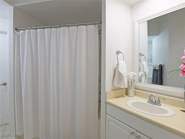 a bathroom with a shower and a sink