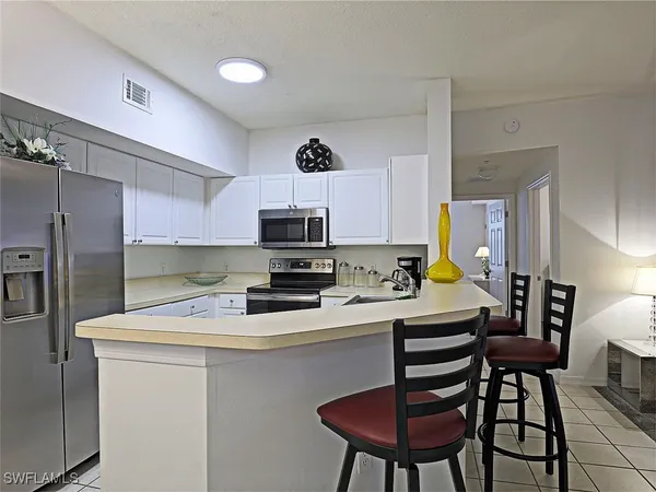 a kitchen with stainless steel appliances a stove a sink a stove a microwave and cabinets