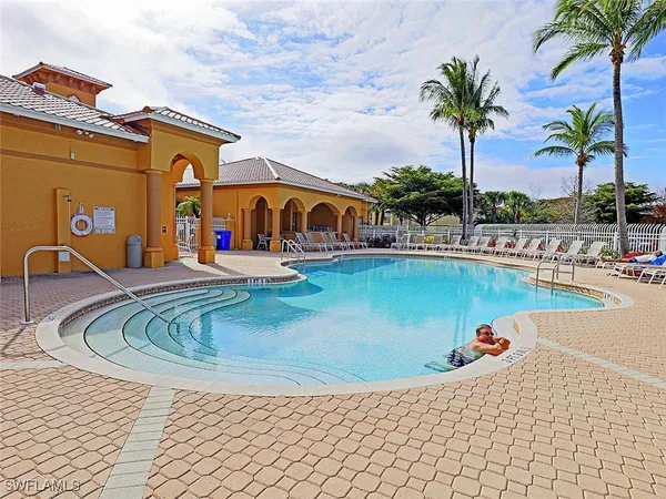 a view of swimming pool with outdoor seating