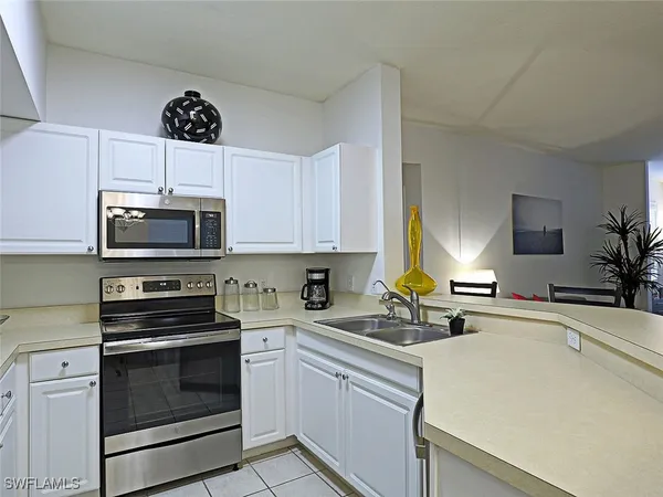 a kitchen with stainless steel appliances a stove a sink a stove and cabinets