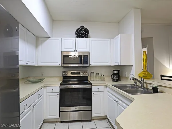 a kitchen with a sink cabinets and stainless steel appliances