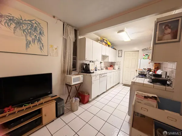 a kitchen with a stove a sink and a microwave