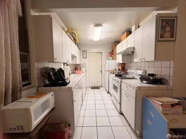 a kitchen with a sink a stove and cabinets