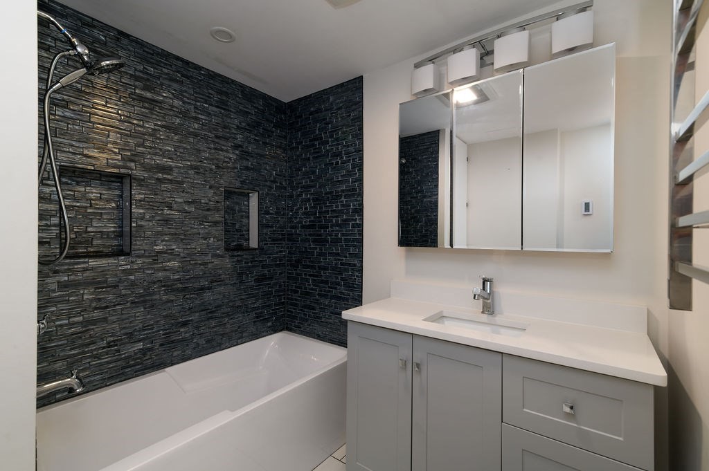 382-384 Adams Street, Unit 3841 Boston, MA 02122 - Photo 15 of 16 a bathroom with a sink and a bathtub