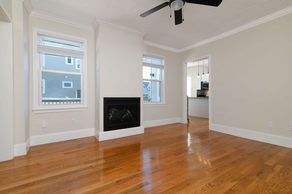 382-384 Adams Street, Unit 3841 Boston, MA 02122 - Photo 9 of 16 a view of an empty room with window and wooden floor