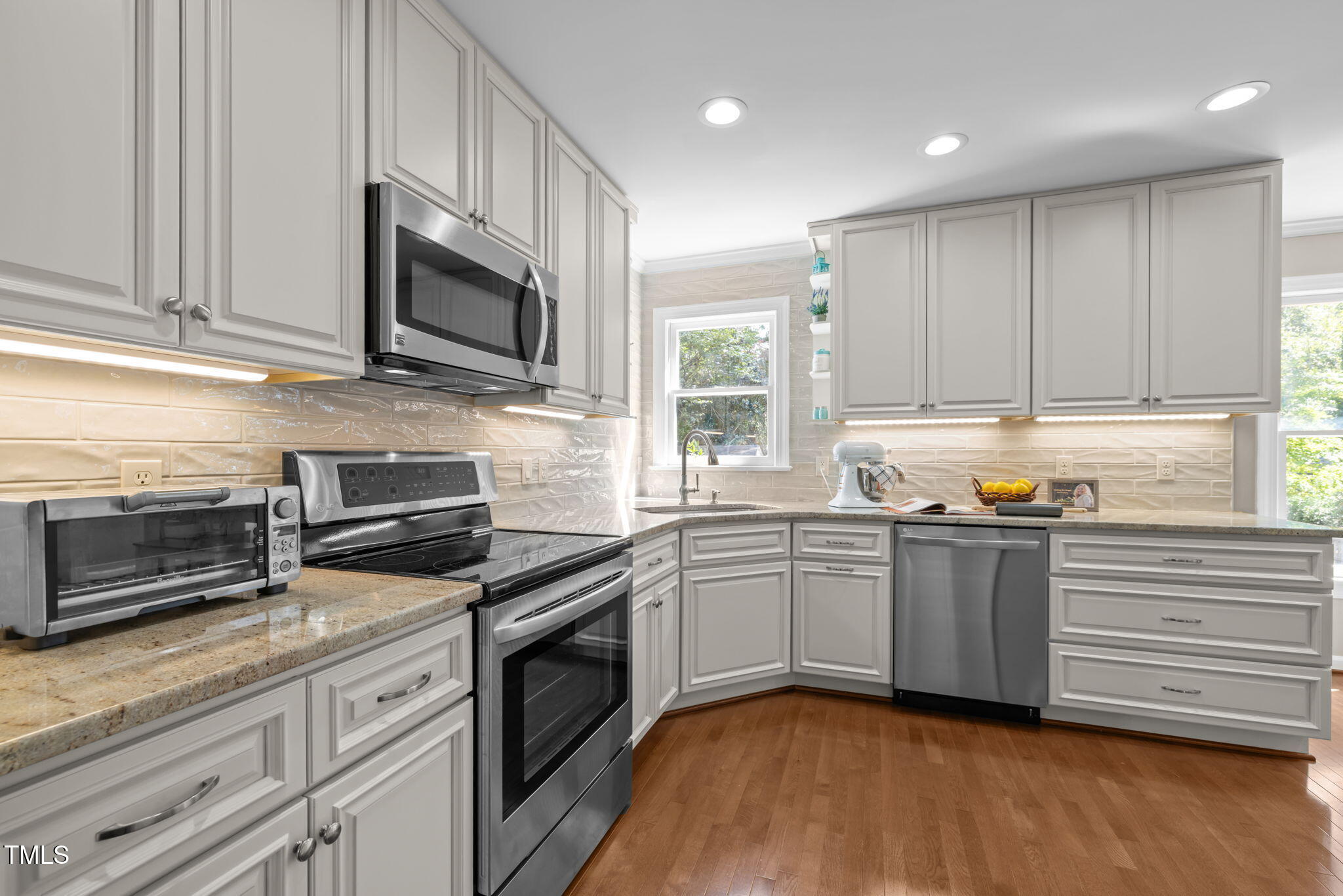 5909 Stable Court Raleigh, NC 27612 - Photo 11 of 45 a kitchen with stainless steel appliances granite countertop a stove a sink and a microwave