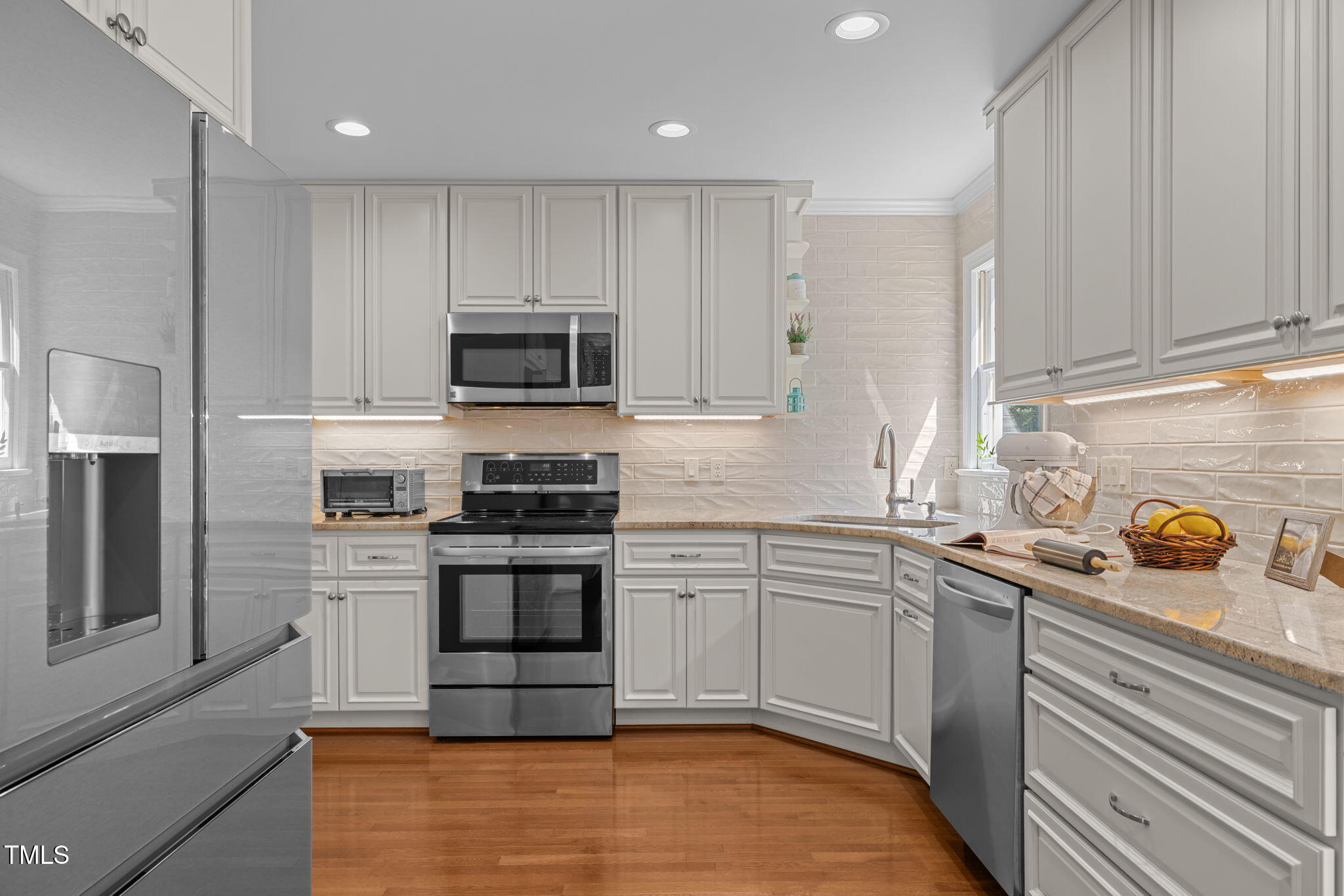5909 Stable Court Raleigh, NC 27612 - Photo 12 of 45 a kitchen with granite countertop a sink and stainless steel appliances