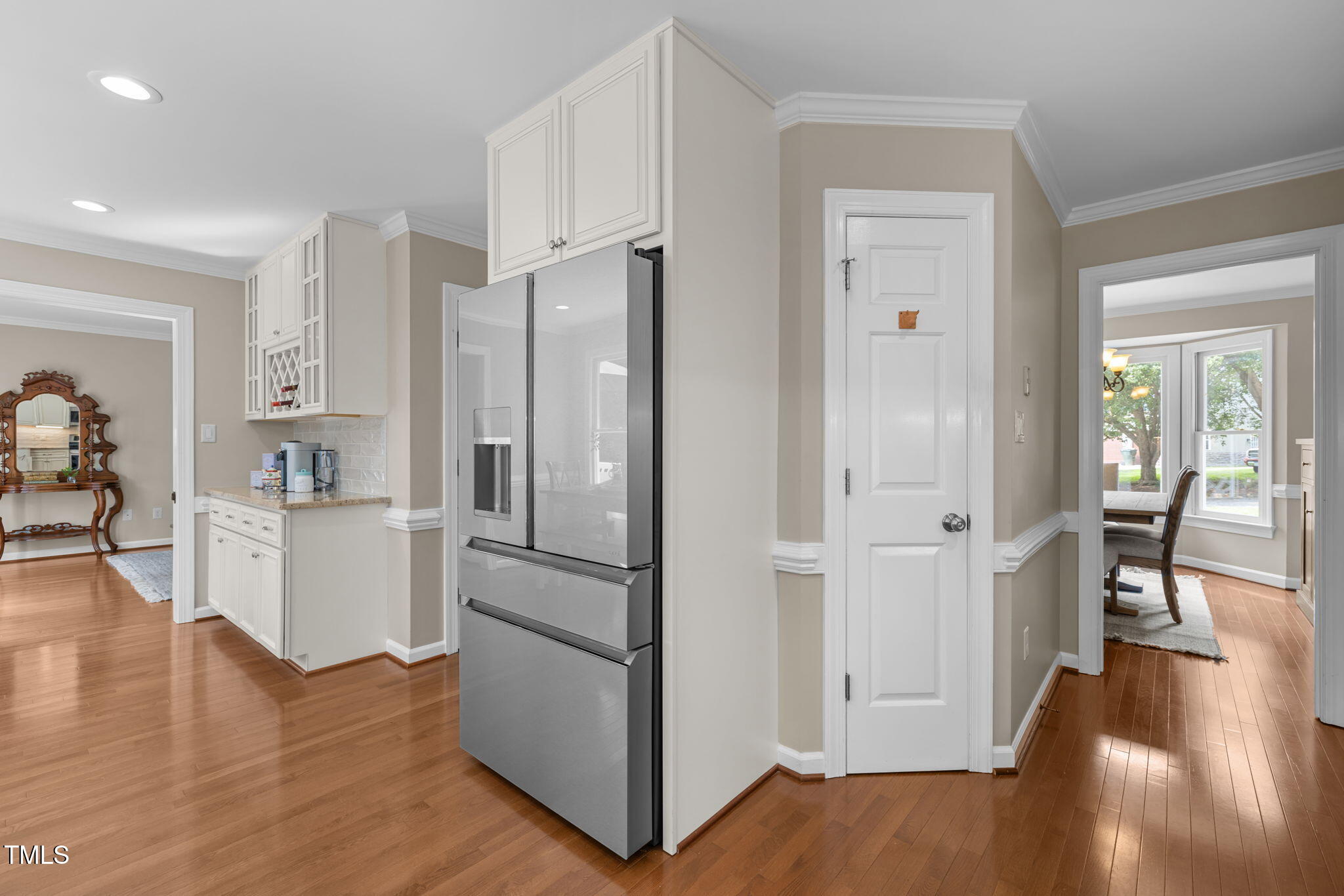 5909 Stable Court Raleigh, NC 27612 - Photo 14 of 45 a kitchen with white cabinets and wooden floor