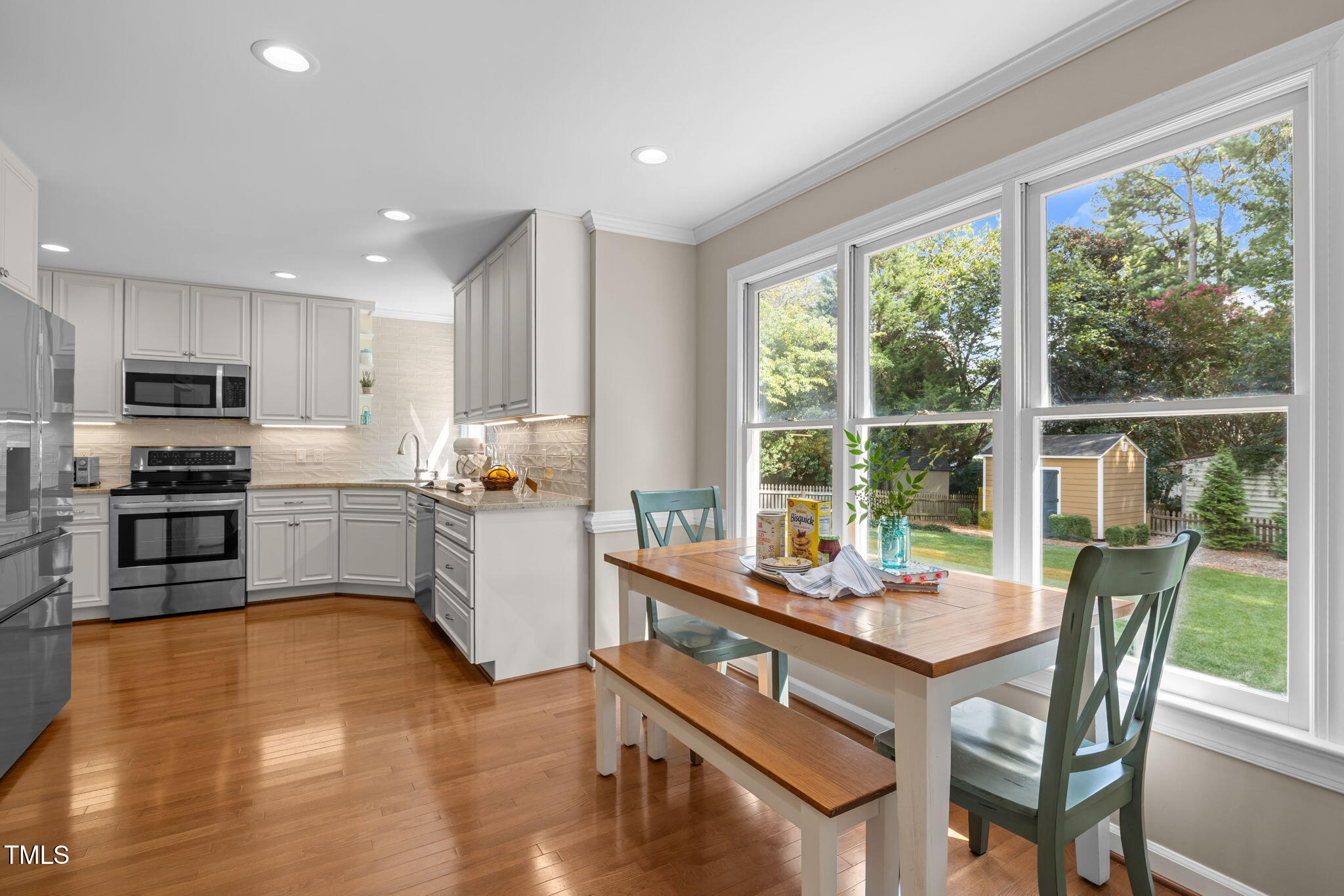 5909 Stable Court Raleigh, NC 27612 - Photo 16 of 45 a kitchen with a sink a counter top space stainless steel appliances and a large window