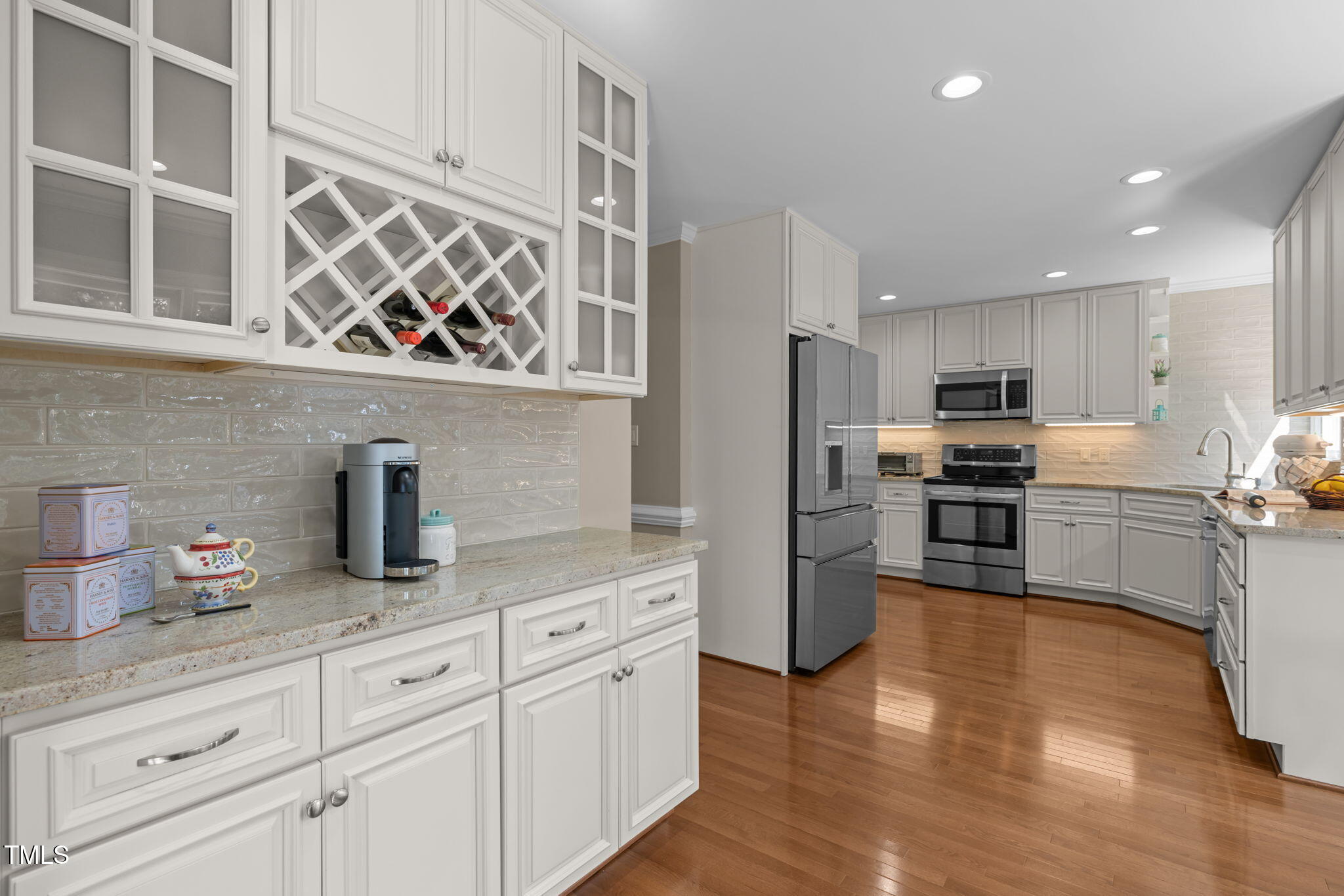 5909 Stable Court Raleigh, NC 27612 - Photo 17 of 45 a kitchen with granite countertop stainless steel appliances and wooden cabinets