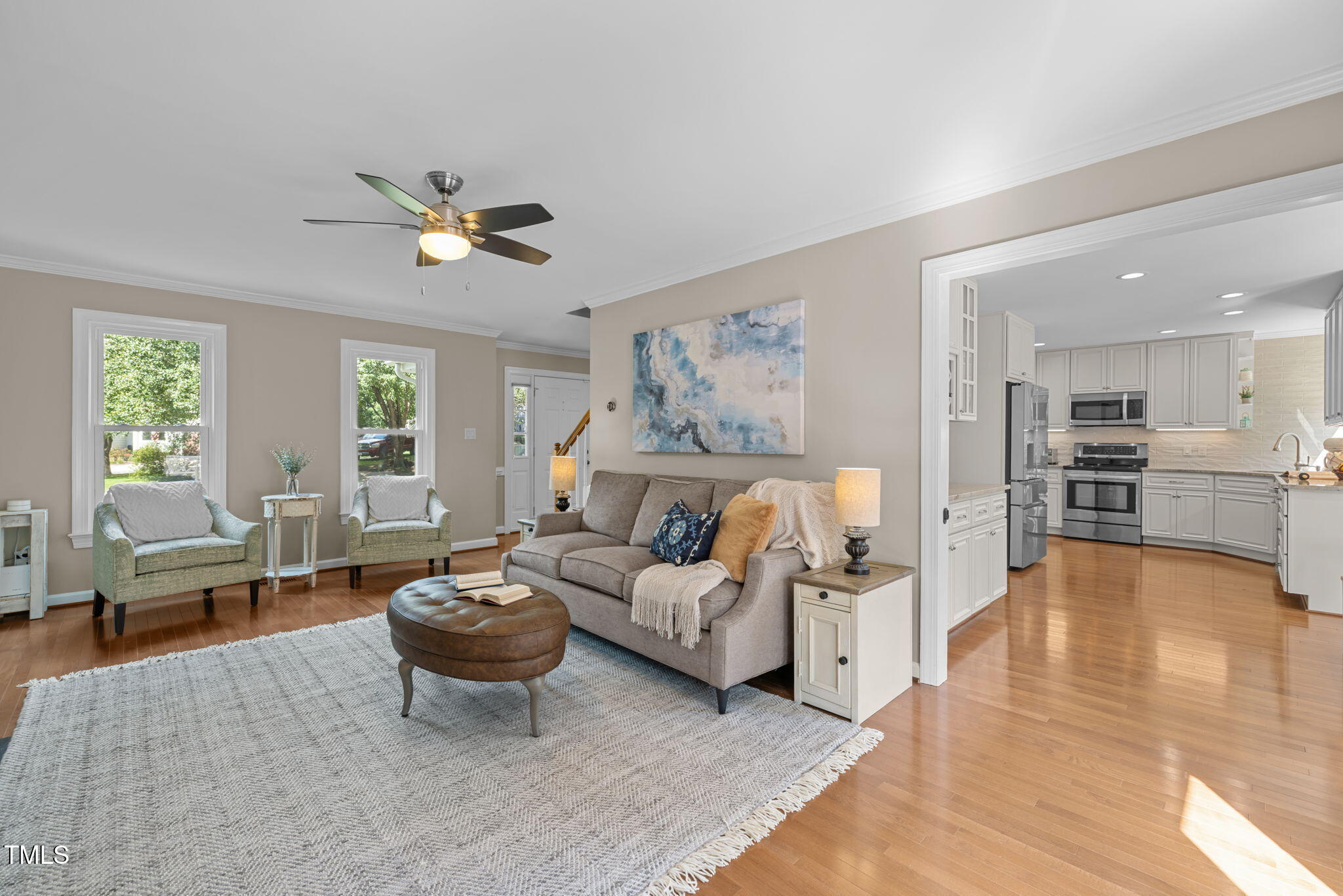 5909 Stable Court Raleigh, NC 27612 - Photo 18 of 45 a living room with furniture wooden floor and a large window