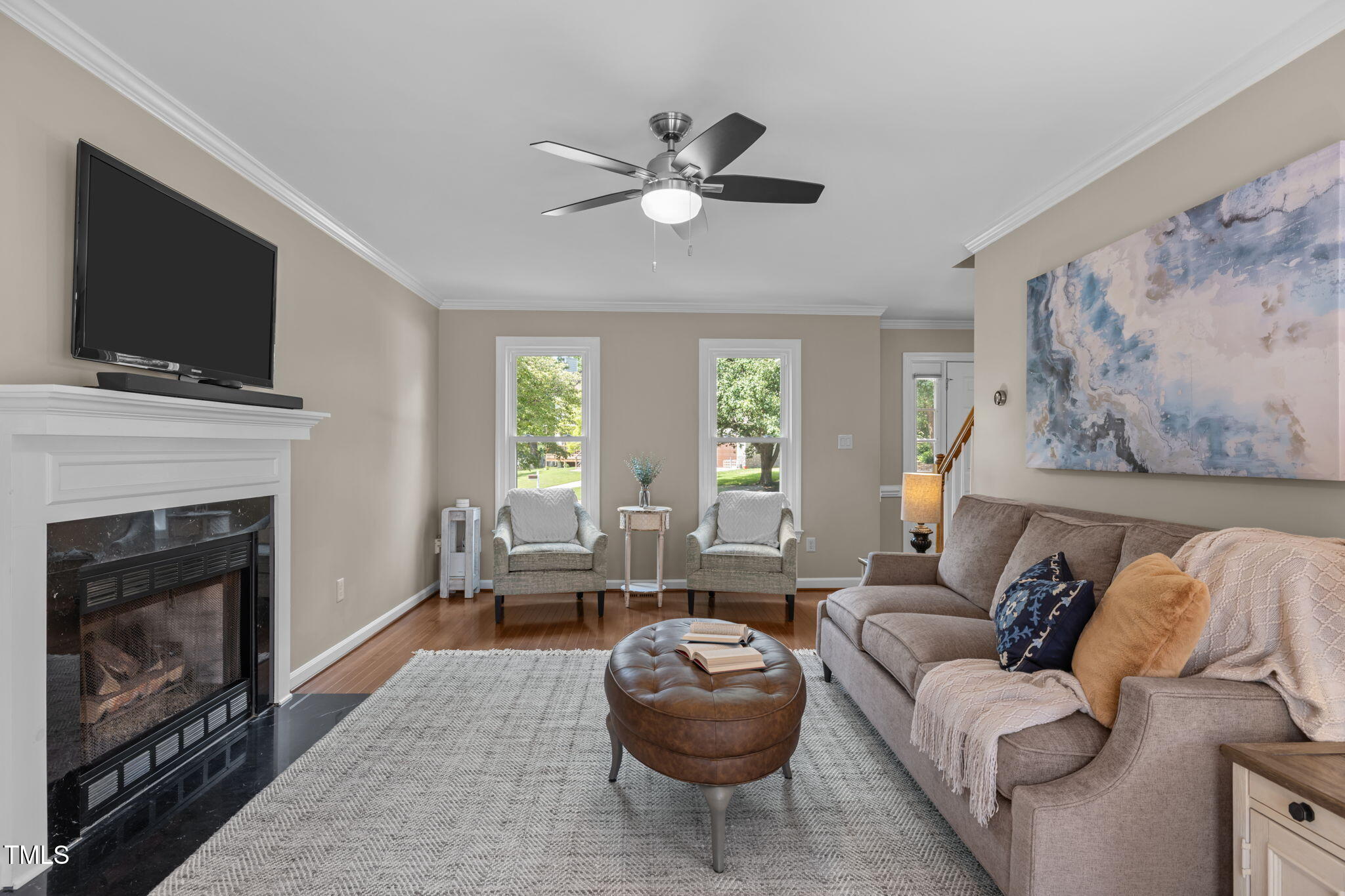 5909 Stable Court Raleigh, NC 27612 - Photo 19 of 45 a living room with furniture a flat screen tv and a fireplace